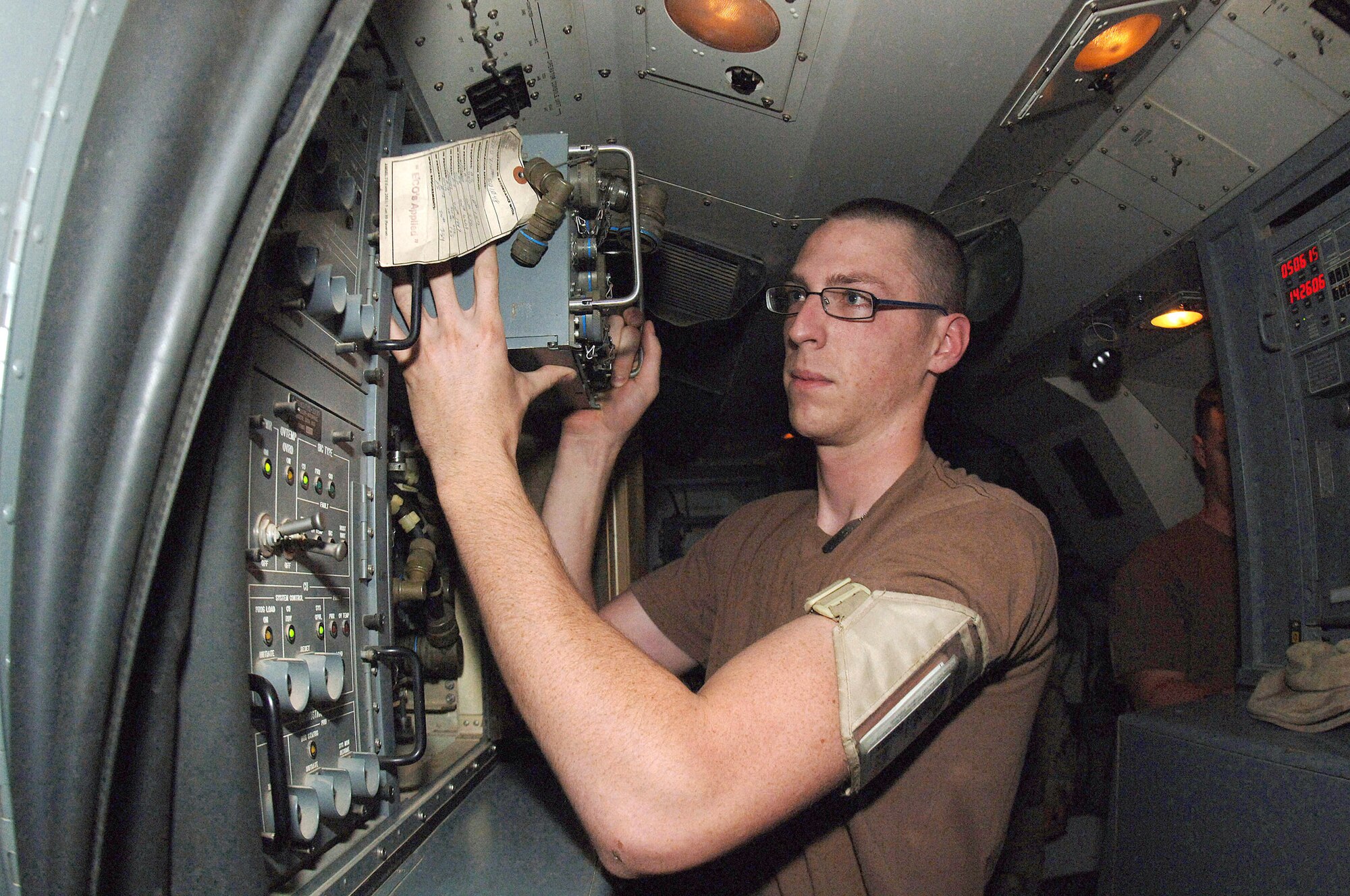 BALAD AIR BASE, Iraq -- Senior Airman Marquis Perkins removes a computer unit for repairs. Senior Airman Perkins is assigned to the 727th Expeditionary Air Control Squadron and is deployed from Mountain Home Air Force Base, Idaho. (U.S. Air Force photo by Staff Sgt. Chad Chisholm)
