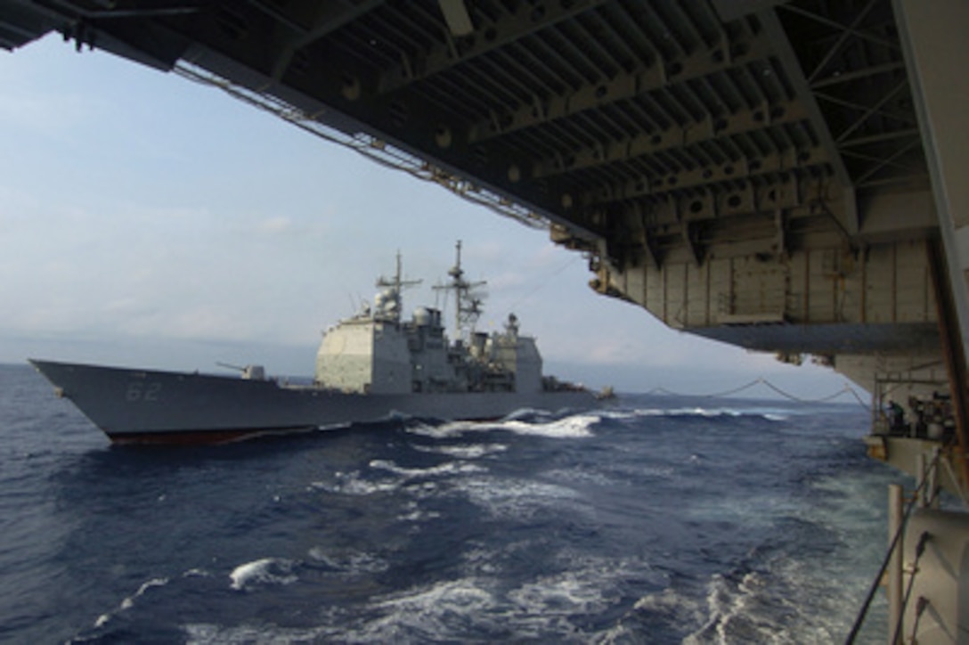 The Navy guided missile cruiser USS Chancellorsville (CG 62) comes alongside the aircraft carrier USS Kitty Hawk (CV 63) for replenishment at sea on Aug. 25, 2005. Chancellorsville is a part of the Kitty Hawk Strike Group, which is operating at sea from its homeport of Yokosuka, Japan. 