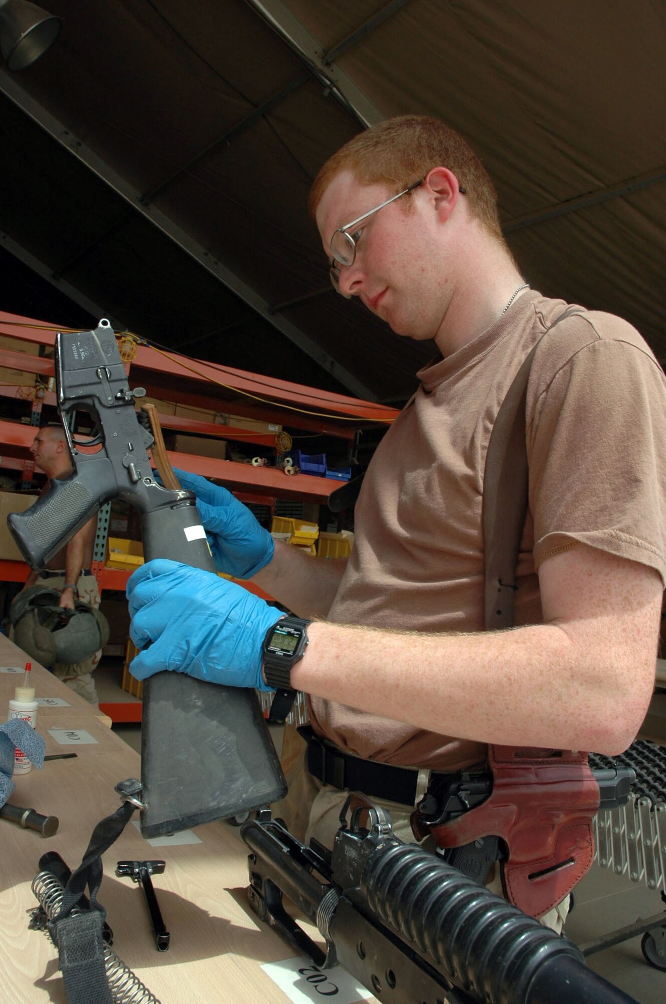 BAGHDAD, Iraq -- Airman 1st Class Paul Brotherton ensures customers are armed with clean and serviceable weapons and ammunition.  Weapons stored in the armory here are disassembled and cleaned and the ammunition is checked for cracks and warping every two weeks.  Airman Brotherton is assigned to the 447th Expeditionary Logistics Readiness Squadron and is deployed from Kadena Air Base, Japan. (U.S. Air Force photo by Senior Airman Chawntain Sloan)