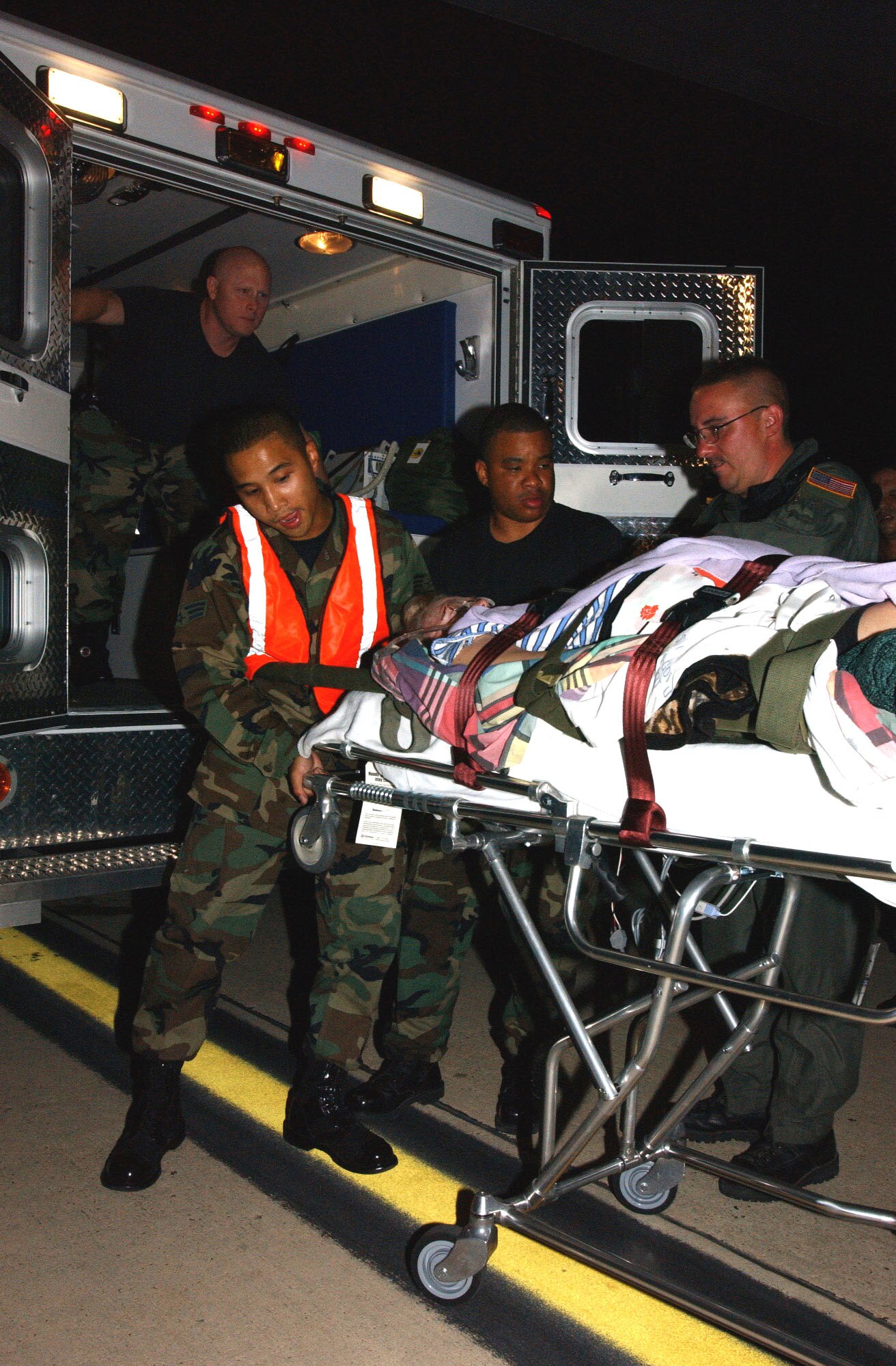 LACKLAND AIR FORCE BASE, Texas -- Medical patients evacuated from Keesler Air Force Base, Miss., in the wake of Hurricane Katrina are unloaded from a C-130 Hercules here Aug. 30. Their medical care will be continued at Wilford Hall Medical Center. The C-130 and aircrew are from the Puerto Rico Air National Guard. (U.S. Air Force photo by Senior Airman Heather M. Norris)