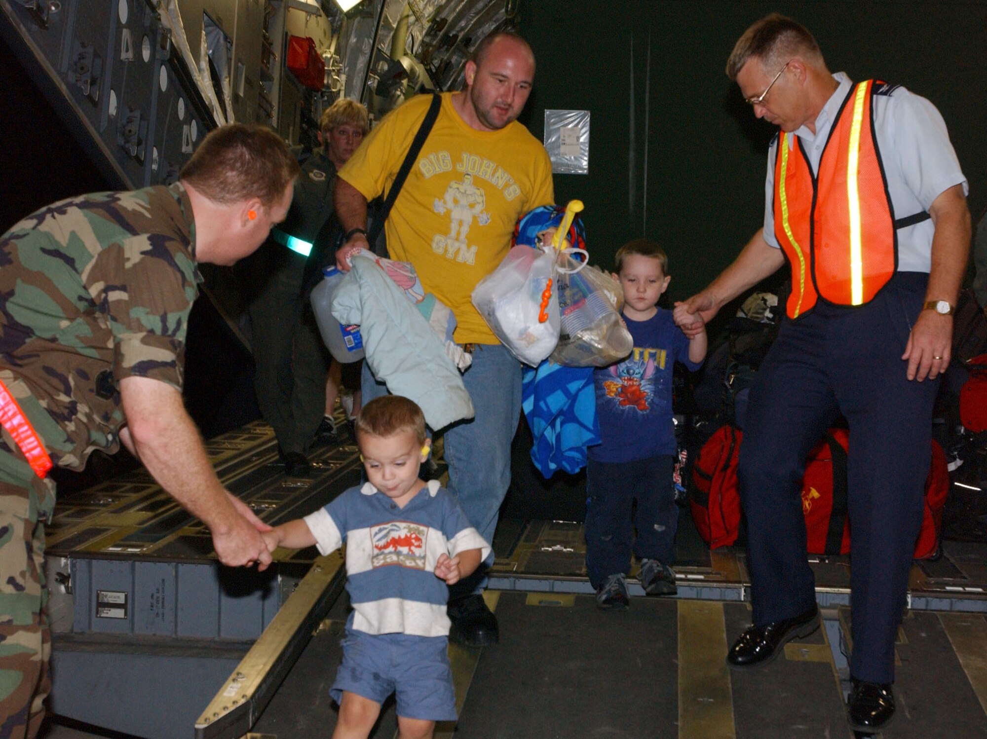 LACKLAND AIR FORCE BASE, Texas - Airmen and their families depart a C-17 Globemaster III after being evacuated from Keesler Air Force Base, Miss., in the wake of Hurricane Katrina here Aug. 30. The C-17 and aircrew are from the Mississippi Air National Guard. (U.S. Air Force photo by Senior Airman Heather M. Norris) 