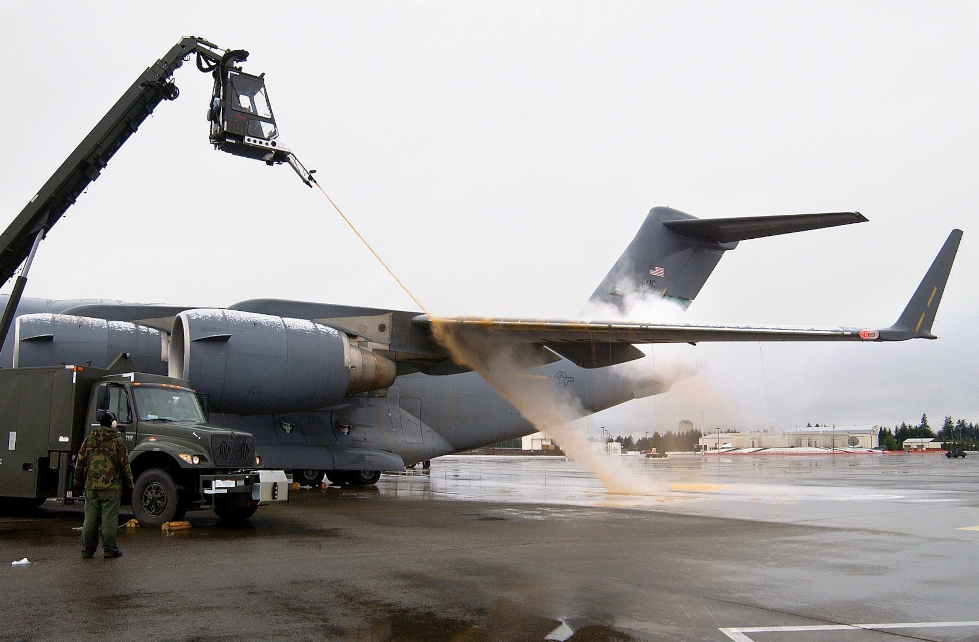 MCCHORD AIR FORCE BASE, Wash. (AFPN) -- A C-17 Globemaster III is de-iced after two bands of heavy snow blanketed the base. (U.S. Air Force photo by Kristin Royalty)
