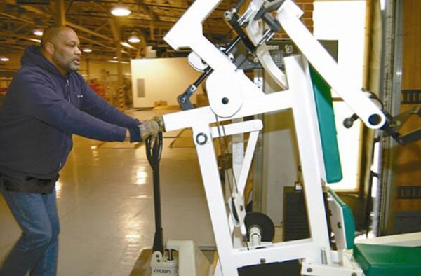 WRIGHT-PATTERSON AIR FORCE BASE, Ohio (AFMCNS) -- Craig Milligan with base movers uses a hand cart to move exercise equipment into a delivery truck. Mr. Milligan was at the 88th Mission Support Group Services Division supply warehouse, to transport fitness equipment to the base freight terminal for shipment overseas. The equipment will be used by U.S. Army members who are deployed in Afghanistan. (Air Force photo by Spencer P. Lane)