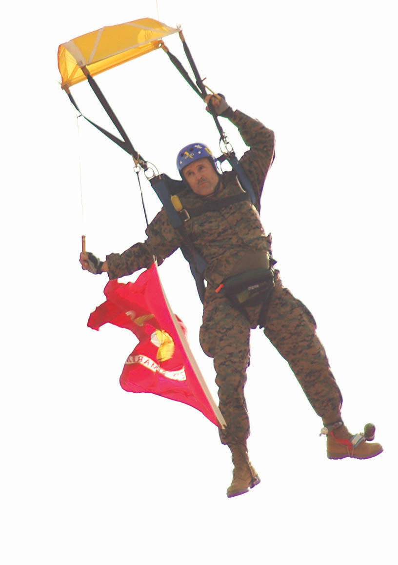 Master Gunnery Sgt. Richard L. Williams, Marine Air Control Squadron 1 communications/electronics chief, steers his parachute toward the drop zone inside the Canon Air Defense Complex Dec. 1. MACS-1 Commanding Officer Lt. Col. Tim J. Pierson reenlisted Williams inside a Cessna C-206 before jumping out of the plane and completing the ceremony in mid freefall.
