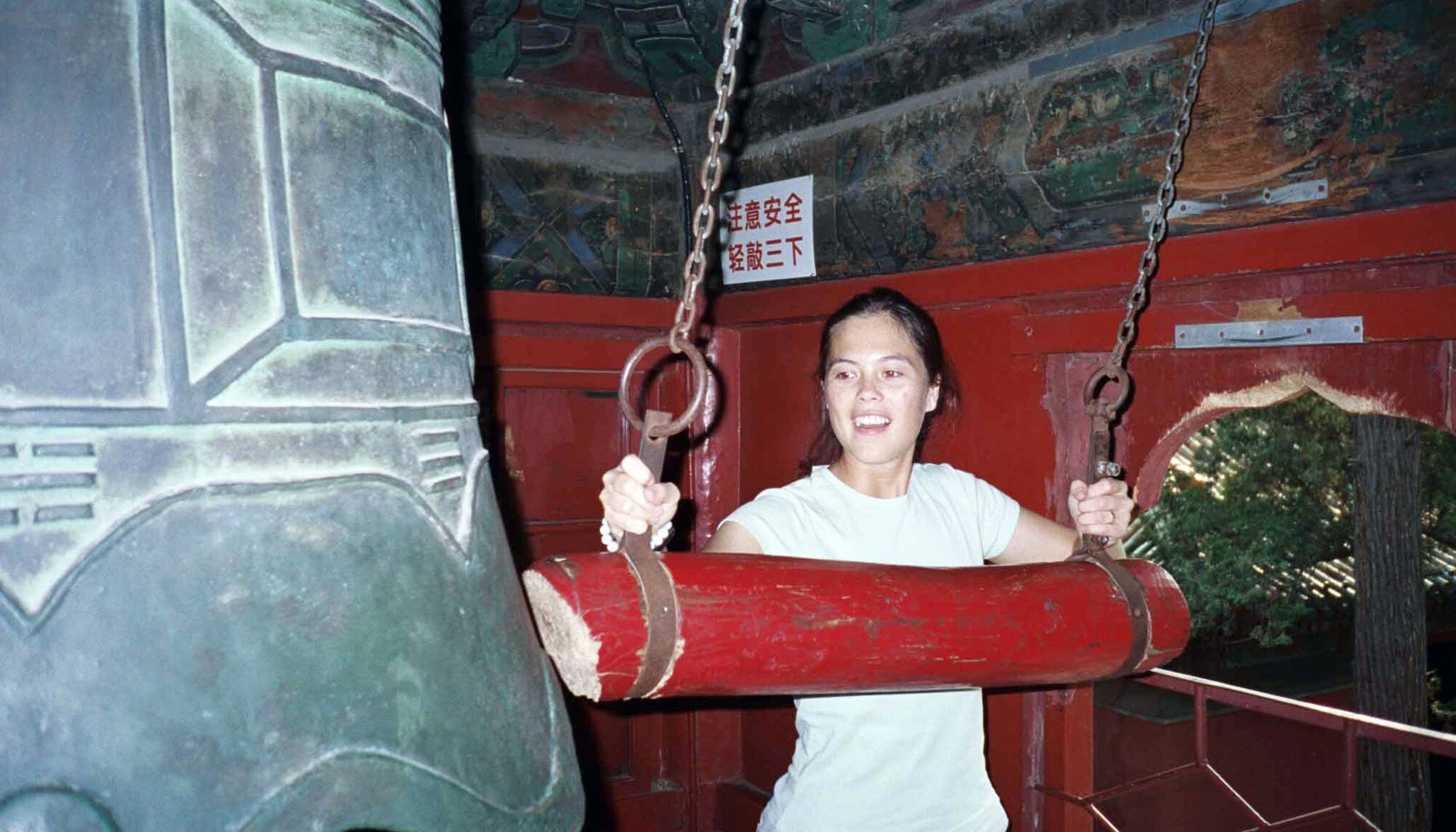 BEIJING (AFPN) -- Capt. Mae-Li Allison rings a bell in Bei Hai Park in the center of the city. She went to China as part of the Language and Area Studies Immersion program. The LASI is designed to build a force of culturally savvy officers who can meet the need of communicating with a developing world. Captain Allison is an executive officer at the Air Armament Center at Eglin Air Force Base, Fla. (U.S. Air Force photo)