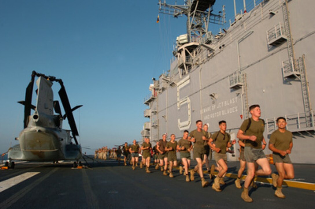 Marines of the 11th Marine Expeditionary Unit perform their physical training on the flight deck of the amphibious assault ship USS Peleliu (LHA 5) as the ship operates in the Pacific Ocean on Nov. 12, 2005. Peleliu is off the coast of Southern California for an expeditionary strike group exercise. 