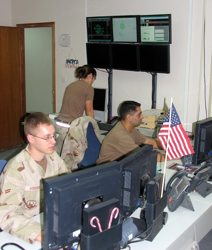 SOUTHWEST ASIA (AFPN) -- Airman 1st Class Noah Gossard (left) and Airman 1st Class Heather Witte monitor and coordinate responses in the critical communication systems here. The airmen maintain communications support for base and aircraft conducting operations in Iraq, Afghanistan and the Horn of Africa.  (U.S. Air Force photo by Staff Sgt. Scott Campbell)
