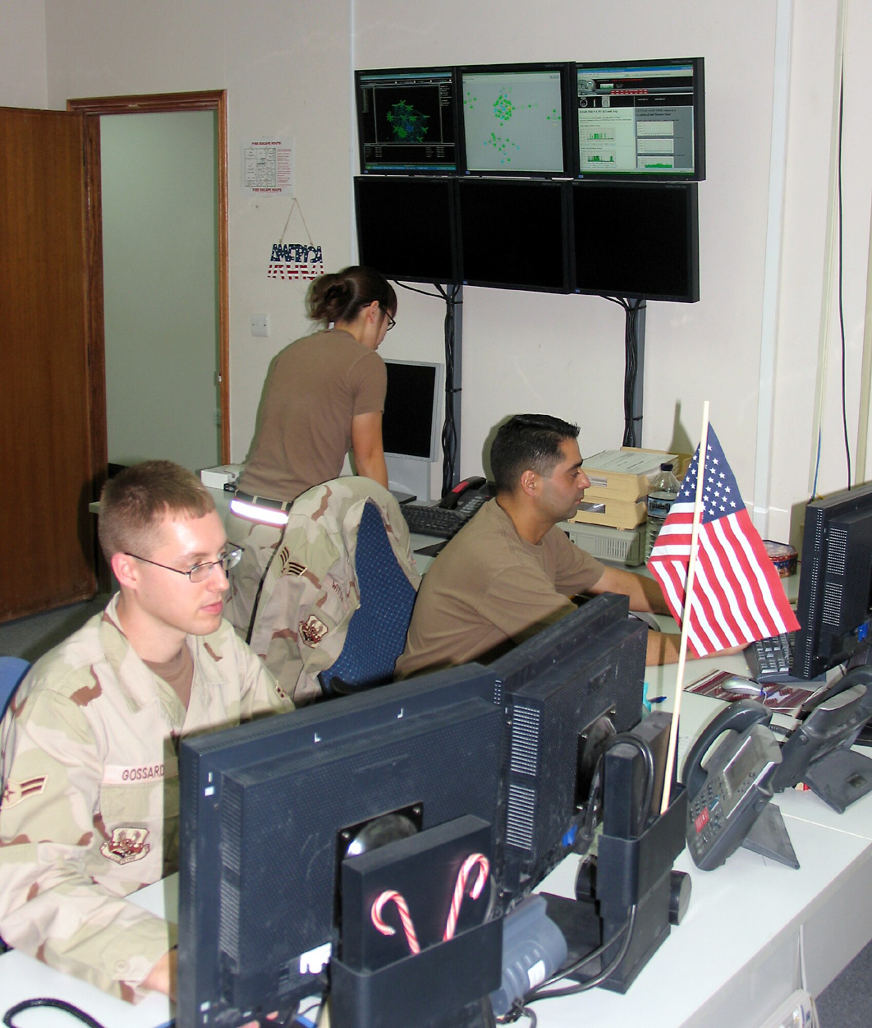 SOUTHWEST ASIA (AFPN) -- Airman 1st Class Noah Gossard (left) and Airman 1st Class Heather Witte monitor and coordinate responses in the critical communication systems here. The airmen maintain communications support for base and aircraft conducting operations in Iraq, Afghanistan and the Horn of Africa.  (U.S. Air Force photo by Staff Sgt. Scott Campbell)
