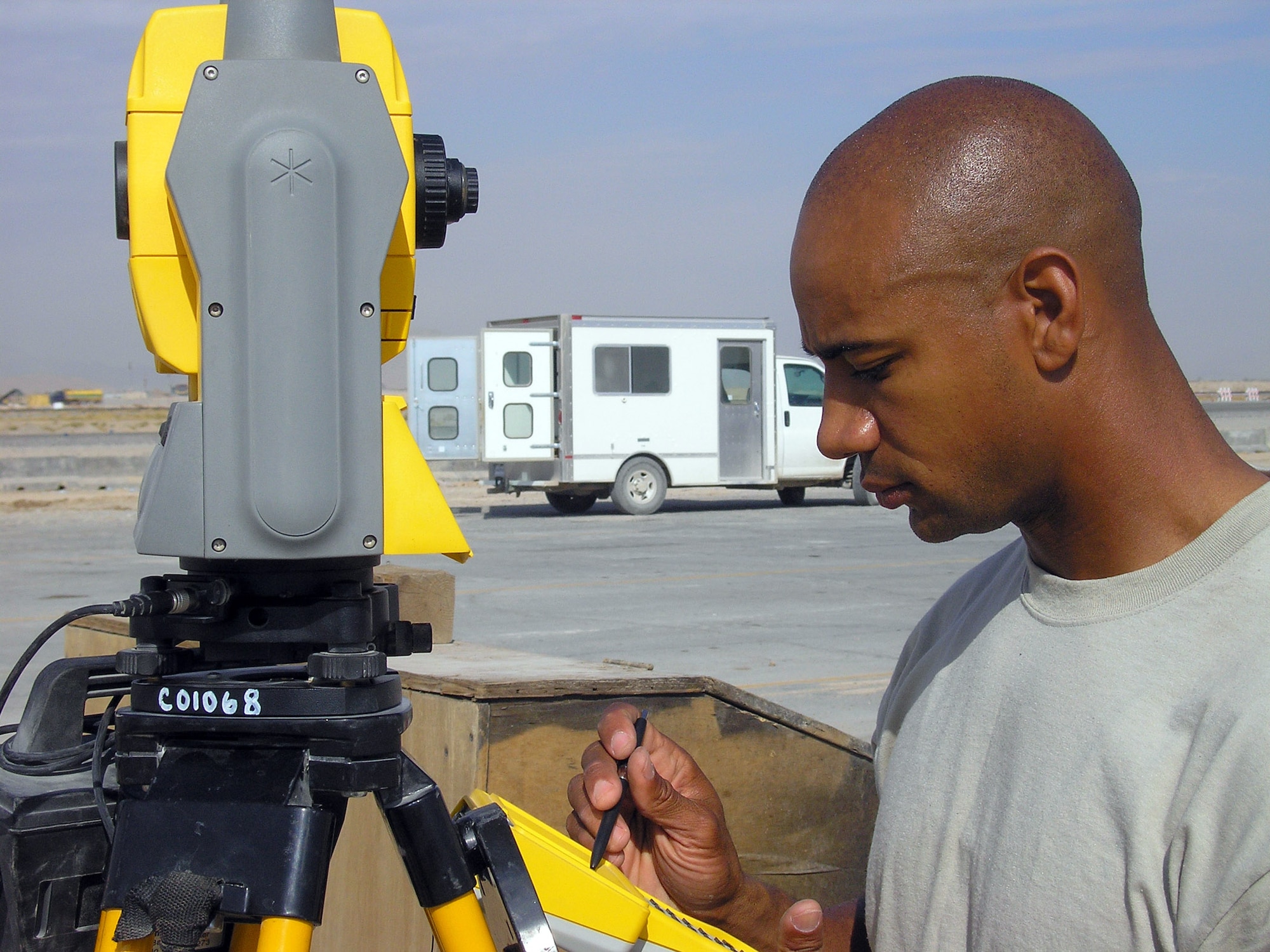 KANDAHAR AIRFIELD, Afghanistan (AFPN) -- Tech. Sgt. Lineus Davis calibrates a geodimeter to survey work being done on the flightline here. Sergeant Davis is an engineering assistant craftsman with the 451st Air Expeditionary Group civil engineer flight. He is from Wilmington, N.C., and deployed from Pope Air Force Base, N.C. (U.S. Air Force photo by Tech. Sgt. Virgil McGee)