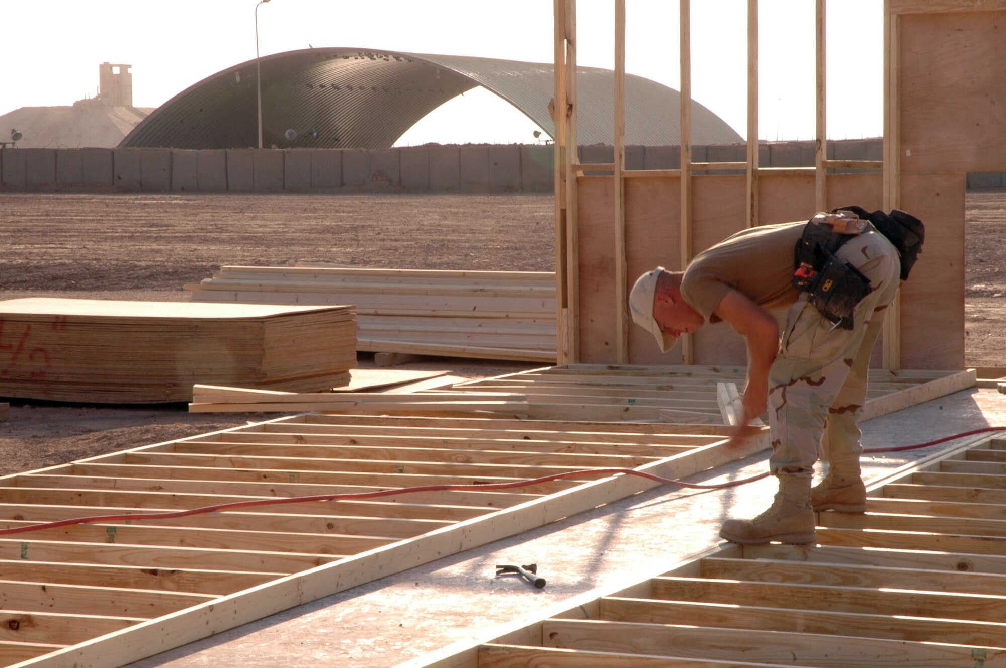 FORWARD OPERATION BASE QAYYARAH WEST, Iraq (AFPN) -- Senior Airman Jesse Gent drives in a nail on a new building project here. Airman Gent is a structural journeyman with the 557th Expeditionary Red Horse Squadron. (U.S. Army photo by Spc. Jeremy D. Crisp)