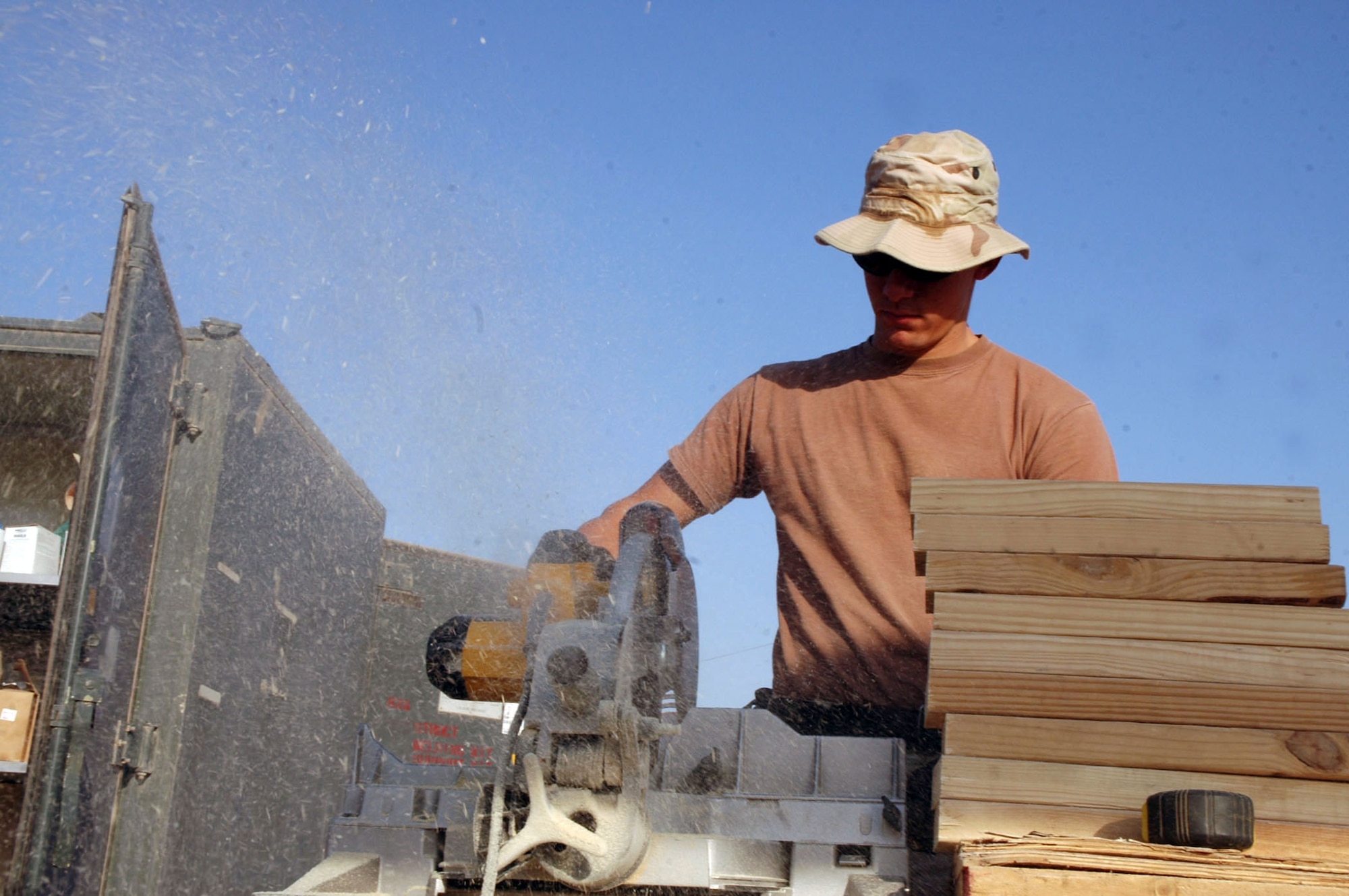 FORWARD OPERATION BASE QAYYARAH WEST, Iraq (AFPN) -- Senior Airman Thomas Miller cuts a stabilizing block for a new building here. Airman Miller is a carpenter with the 557th Expeditionary Red Horse Squadron and deployed from Ellsworth Air Force Base, S.D. (U.S. Army photo by Spc. Jeremy D. Crisp)