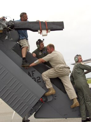 PATRICK AIR FORCE BASE, Fla. - The Air Force Reserve Command's 920th Maintenance Group maintainers fold an HH-60G Pave hawk rescue helicopter for transport in a C-5 Galaxy to support Hurricane Rita relief efforts. (U.S. Air Force photo by Senior Airman Heather Kelly)