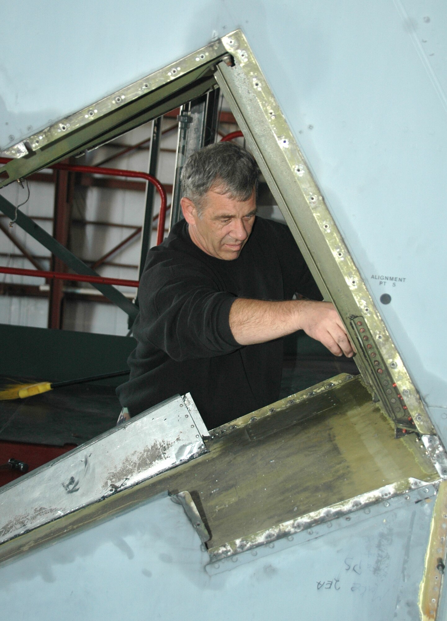 TAIL WORK -- Tech. Sgt. David J. Pelletier, 439th Maintenance Squadron, Westover Air Reserve Base works on the tail of the C-5 inside the pull-through hangar.