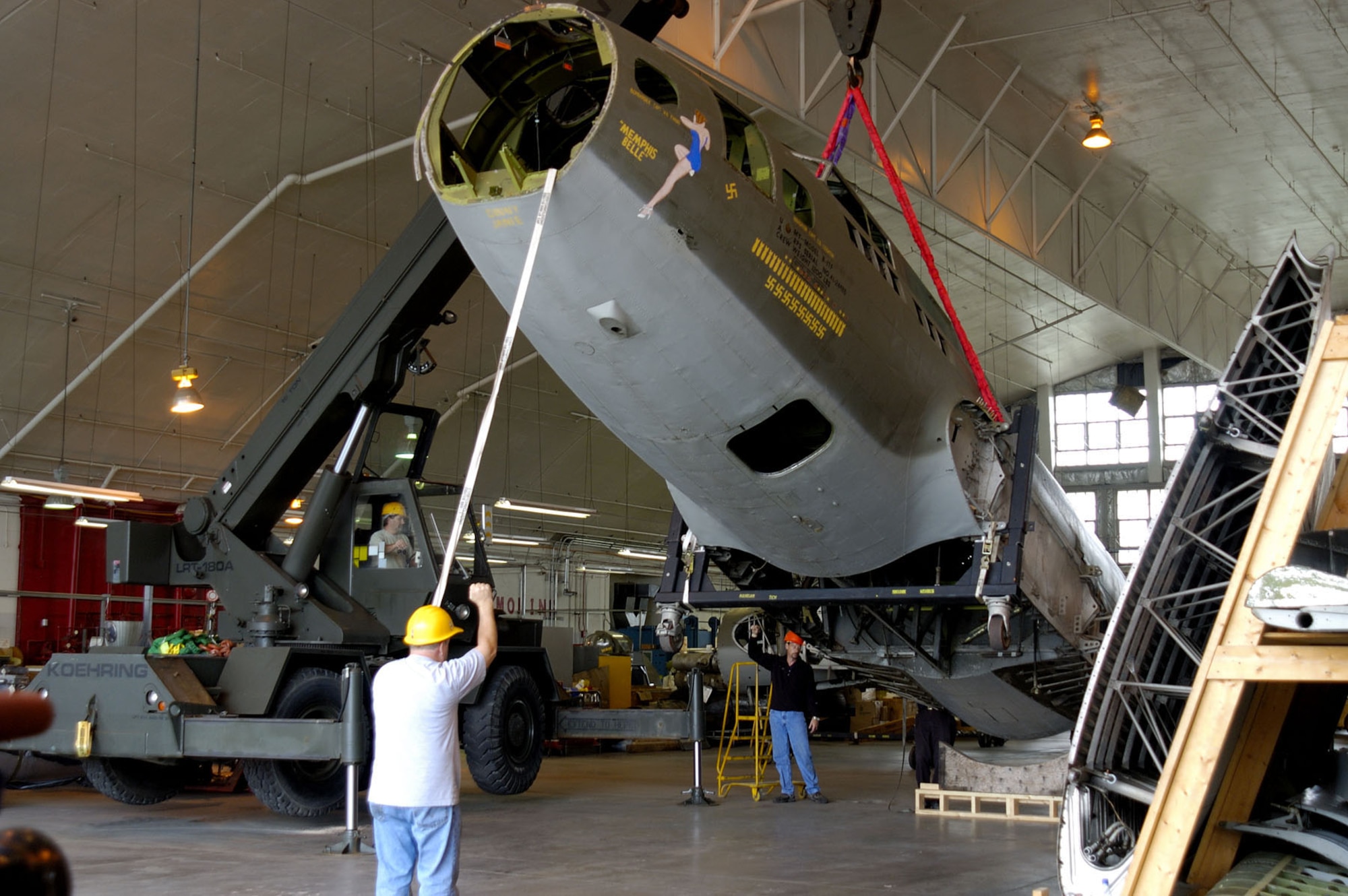 DAYTON, Ohio (10/2005) -- (From left to right) 88th Air Base Wing Engineering Equipment Operator Chris Moon and National Museum of the United States Air Force Restoration Technicians Tim Ward and Greg Hassler unload the fuselage of the B-17F "Memphis Belle" into the museum's restoration hangar. (U.S. Air Force photo)