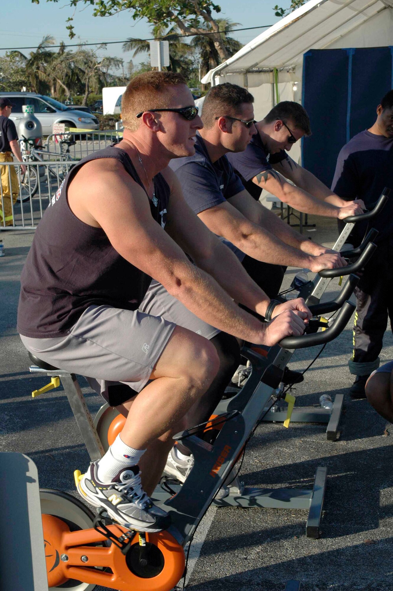 DEERFIELD BEACH, Fla. (AFPN) -- Tech Sgt. Mike Melton, Staff Sgt. Harry Myers and Senior Airman Joe Almony warm up on stationary bikes before taking part in an event at the World Firefighter Combat Challenge here. The team won their event with a time of 4 minutes 25.14 seconds. Sergeant Melton is with the 349th Civil Engineer Squadron at Travis Air Force Base, Calif. Sergeant Myers is with the 60th CES at Travis AFB, Calif., and Airman Almony is with 349th CES at Travis AFB, Calif. (U.S. Air Force photo by Staff Sgt. Matt McGovern)