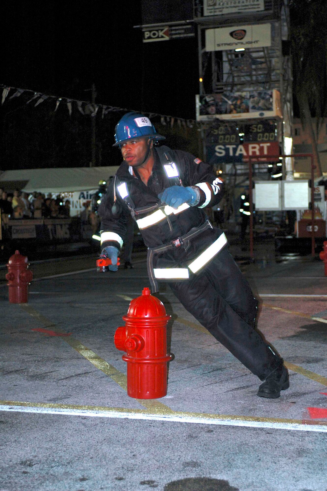DEERFIELD BEACH, Fla. (AFPN) -- Senior Airman Jeff McClendon runs the World Firefighter Combat Challenge stream-light relay here. Airman McClendon is with the 60th Civil Engineer Squadron at Travis Air Force Base, Calif. (U.S. Air Force photo by Staff Sgt. Matt McGovern)
