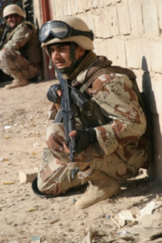 An Iraqi Army soldier attached to the 1st Battalion, 4th Brigade, 1st Iraqi Division watches for suspicious activity during an operation in Kharma, Iraq, on Dec. 2, 2005. 