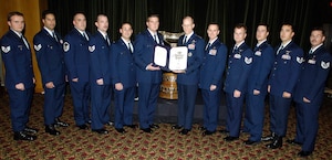 ARLINGTON, Va. (AFPN) - Gen. John D. W. Corley, the Air Force vice chief of staff, (center right) presents the Mackay Trophy to the Airmen who rescued five Soldiers after their helicopter crashed in Iraq. They are (left to right) Staff Sgt. Vincent J. Eckert, Staff Sgt. John Griffin, Master Sgt. Paul Silver, Staff Sgt. Patrick Ledbetter, Maj. Joseph Galletti, Capt. Robert Wrinkle, Capt. Greg Rockwood, Tech. Sgt. Michael Preston, Capt. Bryan Creel, Staff Sgt. Michael Rubio and Tech. Sgt. Thomas Ringheimer. Not present at the ceremony were Tech. Sgt. Matt Leigh and Senior Airman Edward Ha. (U.S. Air Force photo by Donna Parry)