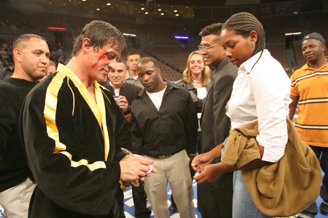 Actor Sylvester Stallone, who plays Rocky in the upcoming 'Rocky' VI movie, signs an autograph for Camp Pendleton Marine Lance Cpl. Lakeya Benton at the Mandalay Bay in Las Vegas Dec. 6. Camp Pendleton boxing coach Anthony J. Gonzales took his team and other Marines to Las Vegas to boost morale and confidence. Some of the Marines may be seen in the movie as extras, cheering at ringside or in the stands.