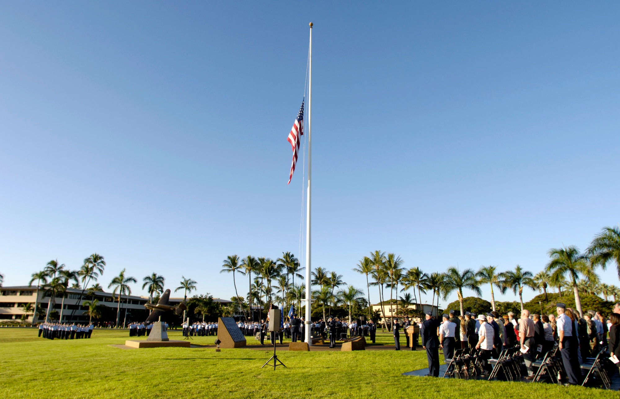 HICKAM AIR FORCE BASE, Hawaii (AFPN) -- Members of the 15th Airlift Wing today commemorated the 64th anniversary of the Dec. 7, 1941 surprise Japanese attack here. The base held a ceremony at the base flagpole to honor the attack on then-Hickam Field, which left 189 dead and 303 wounded. The dining hall in what is now the Pacific Air Force headquarter's building, took a direct hit from a 500-pound bomb, instantly killing 35 men. (U.S. Air Force photo by Tech. Sgt. Shane A. Cuomo)