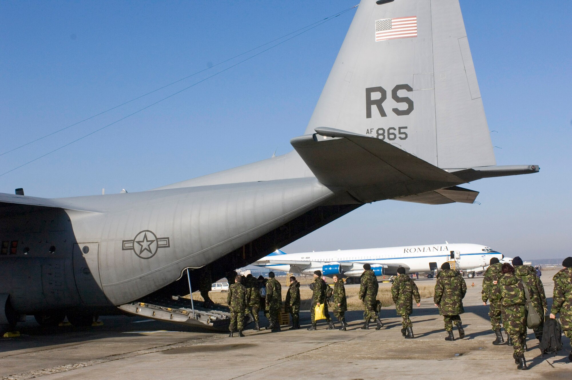 BUCHAREST, Romania (AFPN) -- Romanian army soldiers board a C-130 Hercules on their way to Grafenwoehr, Germany, for training. The "Herc" belongs to the 37th Airlift Squadron at Ramstein Air Base, Germany. (U.S. Air Force photo by Master Sgt. John E. Lasky)
