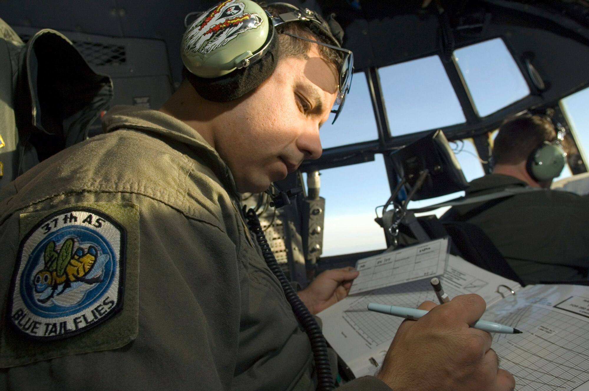 OVER GERMANY (AFPN) -- Staff Sgt. Edward Fry works in cockpit of a C-130 Hercules flying above a cold front pushing through Germany. Sergeant Fry is a flight engineer with the 37th Airlift Squadron at Ramstein Air Base, Germany. (U.S. Air Force photo by Master Sgt. John E. Lasky)
