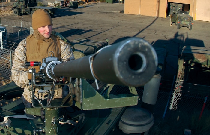 Lance Cpl. Justin Mickibben, Marine Air Control Squadron 1 radar repair technician, and native of West Palm Beach, Fla., mounts an M-2, .50 caliber heavy machine gun on a seven-ton truck before a live fire convoy exercise at the Cannon Air Defense Complex located approximately seven miles south of the air station Dec. 7. Each crew-served weapon was manned by one Marine during the convoy exercise.