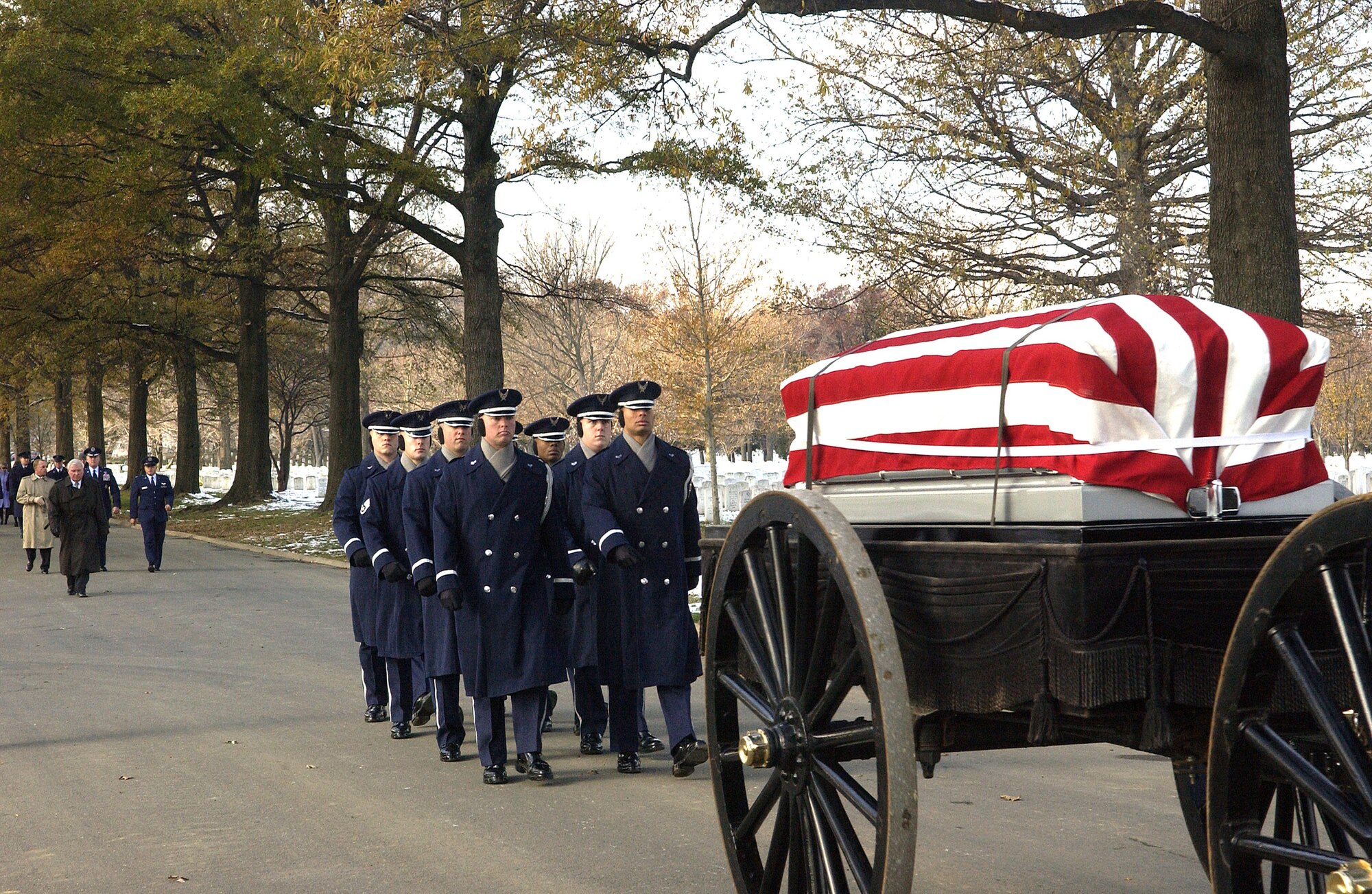 ARLINGTON NATIONAL CEMETERY, Va. (AFPN) -- U.S. Air Force Honor Guardsmen lead the caisson carrying the remains of Col. Wilfred B. Crutchfield and Lt. Col. Ivan E. O'Dell to their gravesite in Arlington National Cemetery. The remains were laid to rest with full military honors here, Dec. 7. The Airmen died in a plane crash in 1968 but their remains were not discovered until October 2004. (U.S. Air Force photo by Thomas Dennis)