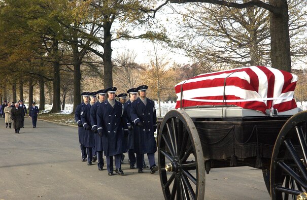 ARLINGTON NATIONAL CEMETERY, Va. (AFPN) -- U.S. Air Force Honor Guardsmen lead the caisson carrying the remains of Col. Wilfred B. Crutchfield and Lt. Col. Ivan E. O'Dell to their gravesite in Arlington National Cemetery. The remains were laid to rest with full military honors here, Dec. 7. The Airmen died in a plane crash in 1968 but their remains were not discovered until October 2004. (U.S. Air Force photo by Thomas Dennis) 