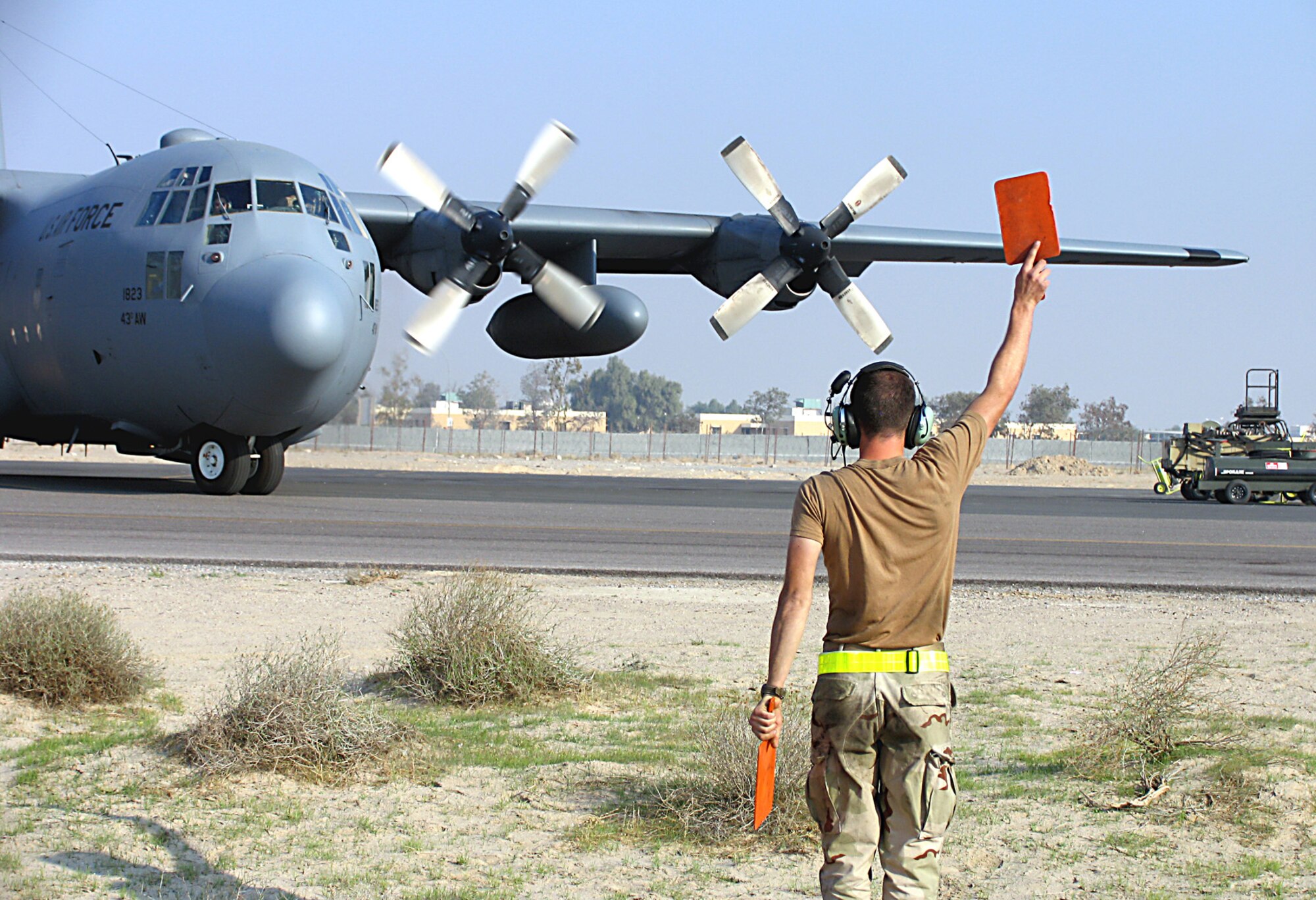 SOUTHWEST ASIA (AFPN) -- Senior Airman Johnathan Feucht marshals a C-130 Hercules before takeoff. Airman Feucht is with the 368th Expeditionary Aircraft Maintenance Squadron. (U.S. Air Force photo by Tech. Sgt. Mark Getsy) 