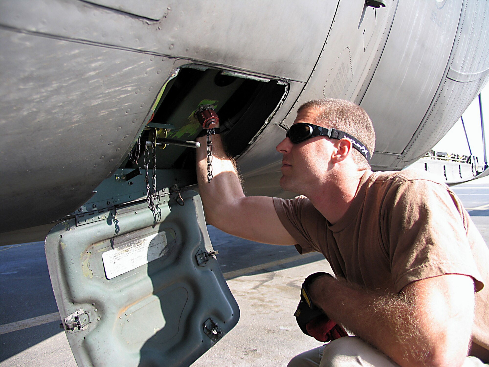 SOUTHWEST ASIA (AFPN) -- Senior Airman Tye Grasshoff checks the hydraulic system as part of the pre-flight inspection. Airman Grasshoff is with the 368th Expeditionary Aircraft Maintenance Squadron. (U.S. Air Force photo by Tech. Sgt. Mark Getsy) 