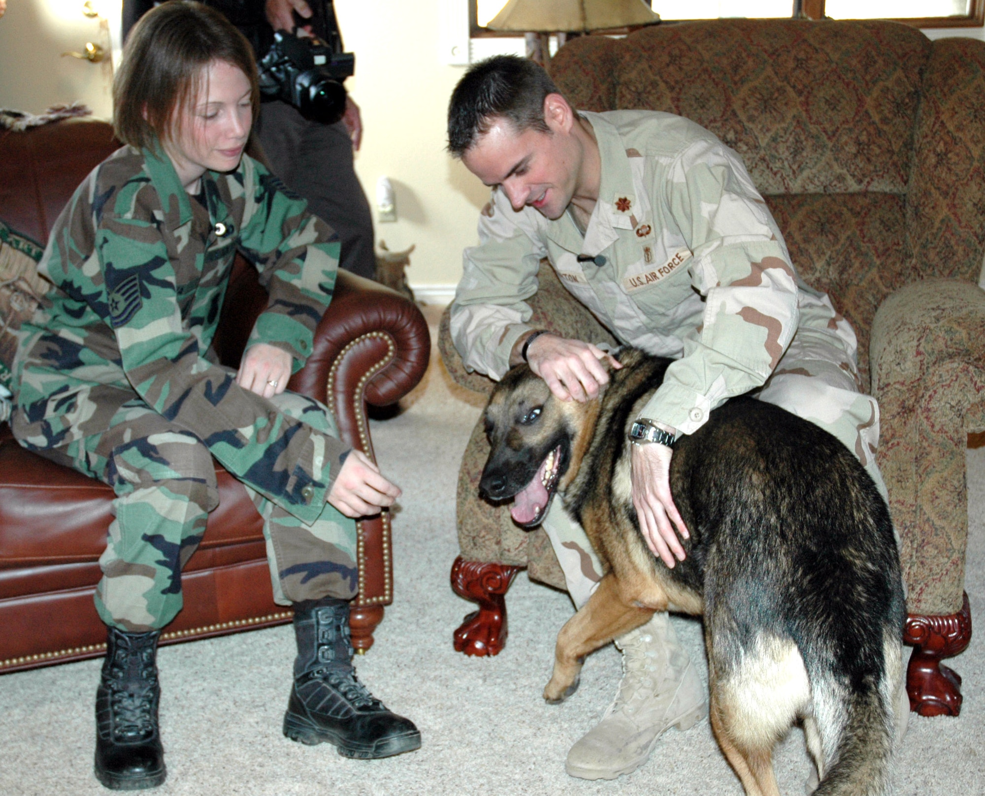MONUMENT, Colo. (AFPN) -- Tech. Sgt. Jamie Dana and her former military working dog, Rex, met Maj. (Dr.) Paul Morton at an animal sanctuary where the sergeant volunteers. Major Morton helped save Sergeant Dana's life after an improvised explosive device detonated under her Humvee near Kirkuk Air Base, Iraq. Major Morton is with the 10th Medical Group at the U.S. Air Force Academy. Sergeant Dana is with the 21st Security Forces Squadron at Peterson Air Force Base, Colo. (U.S. Air Force photo)