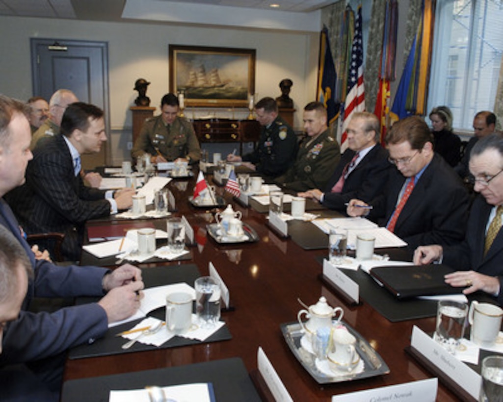 Secretary of Defense Donald H. Rumsfeld (third from right) meets with Polish Minister of National Defense Radek Sikorski (left) in the Pentagon on Dec. 7, 2005. Rumsfeld, Sikorski and their staffs are meeting to discuss defense issues of mutual interest. From left to right are Sikorsky, Assistant Naval and Air Attaché Maj. Piotr Blazeusz, Joint Chief of Staff, J-5 Maj. Walter Grissom, U.S. Army, Chairman of the Joint Chiefs of Staff Gen. Peter Pace, U.S. Marine Corps, Rumsfeld, Assistant Secretary of Defense for International Security Policy Peter Flory, and Director of Northern European Policy Jesse Kelso. 