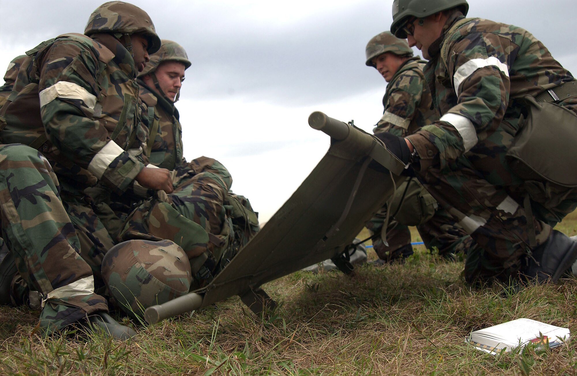 MACDILL AIR FORCE BASE, Fla. (AFPN) -- Airmen load a "wounded" comrade onto a stretcher during an ability to survive and operate exercise. The exercise, held Dec. 7, trains Airman to survive and accomplish their mission under adverse combat conditions. The Airmen are with the 6th Air Mobility Wing here. (U.S. Air Force photo by Senior Airman Jason Robertson)