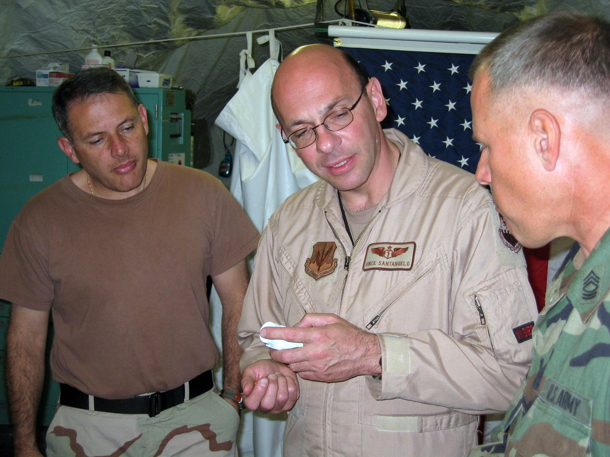 ISLAMABAD, Pakistan (AFPN) -- Master Sgt. Luis Valladares (left) and Lt. Col. (Dr.) Vince Santangelo (center) discuss medication options with a Soldier supporting Pakistani humanitarian relief operations. Sergeant Valladares is an independent duty medical technician and Colonel Santangelo is an air transportable clinic commander. (U.S. Air Force photo by 1st Lt. Erick Saks) 