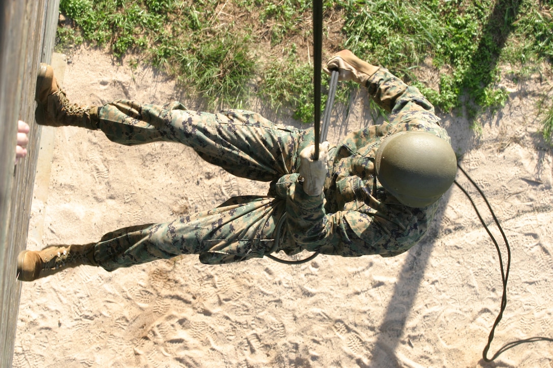 Cpl. Joseph Hallars goes down the rappel tower at Landing Zone Boondocker, Dec. 9, on Marine Corps Base Hawaii, Kaneohe Bay. Marines and Sailors assigned to Marine Corps Air Field went down the tower, ran through the obstacle course and listened to a suicide awareness brief as part of their holiday safety brief.