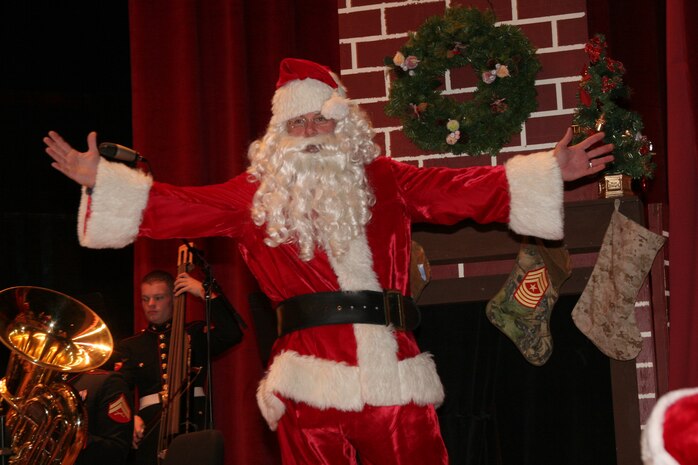 ?Merry Christmas to all, and to all a good night,? says Santa Claus (Sgt. Maj. James M. Ricker, Combat Center sergeant major) at the Commanding General?s Holiday Concert Dec. 11 at Sunset Cinema. Santa burst from the fireplace during Brig. Gen. Douglas M. Stone?s reading of ??Twas the Night Before Christmas.?  The Combat Center commanding general read to children of the Combat Center while the band played musical accompaniment.