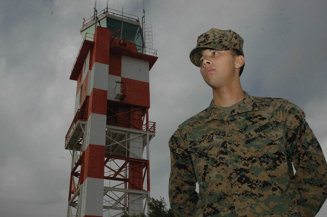 Lance Cpl. Lauro Vera, Headquarters and Headquarters Squadron air traffic controller, stands in front of the station air traffic control tower recently. Vera was recommended for qualification as a precision approach controller Dec. 10 by his primary position instructor, and was approved for qualification Dec. 15. ATC Marines need to qualify in at least two out of eight positions before they officially earn their spot in the ATC military occupational specialty.