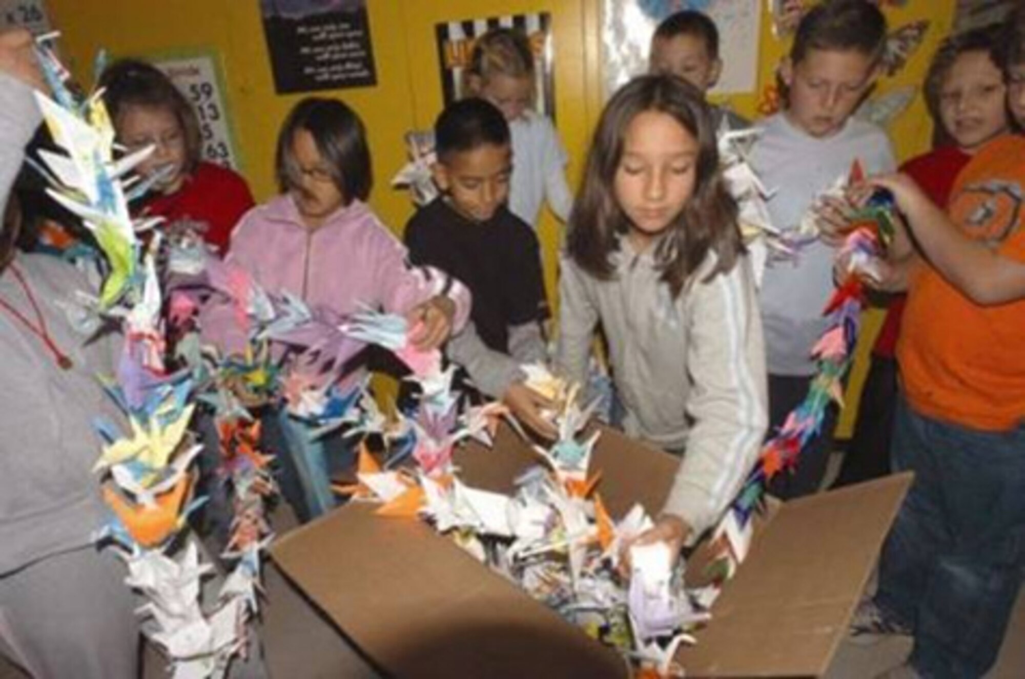 Students from Karla Olsen's fourth-grade class at Branch Elementary School package the paper cranes to be sent to the Peace Park in Hiroshima, Japan. The class, with community support, made over 1,000 paper cranes in support of peace. (Air Force photo by Senior Airman Francesca Carrano) 