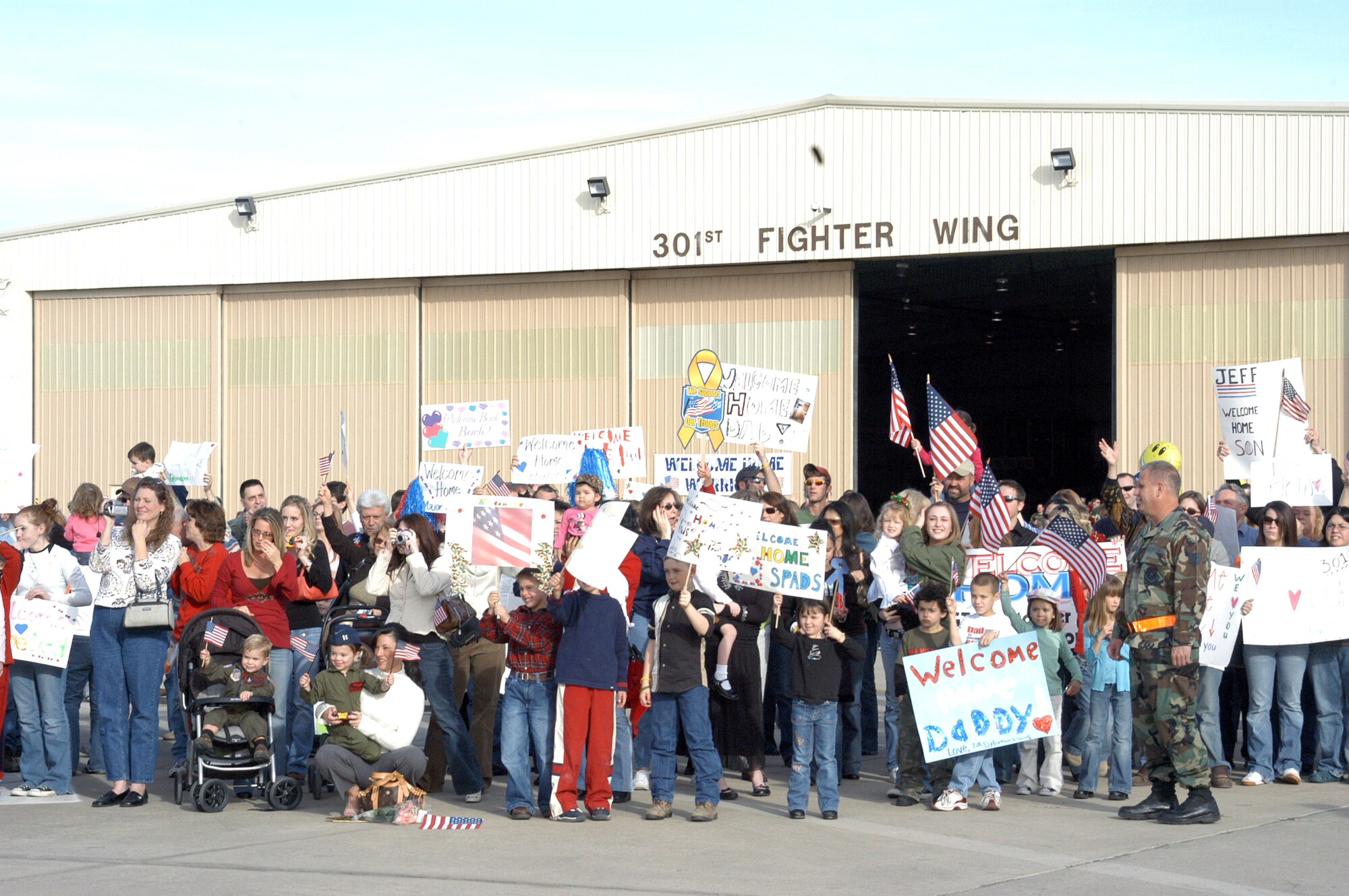 NAVAL AIR STATION – JOINT RESERVE BASE FORT WORTH, Texas (AFPN) -- Family and friends gather on the flightline wait for their loved ones to deplane. More than 150 301st Fighter Wing Airmen returned from Balad Air Base, Iraq Dec. 11. (U.S. Air Force photo by Tech. Sgt. Julie Briden-Garcia)