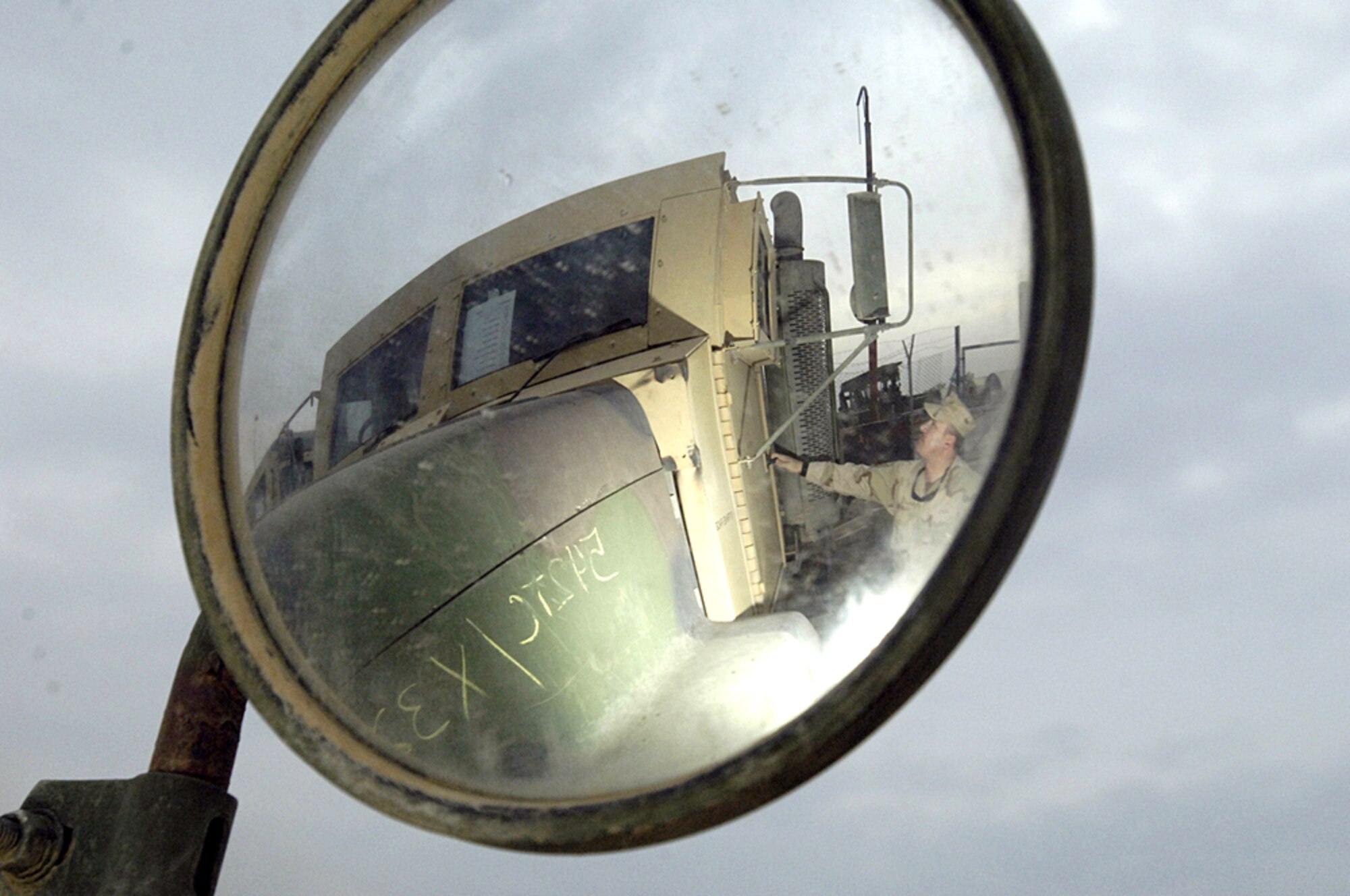 BALAD AIR BASE, Iraq (AFPN) -- Master Sgt. Jon Vance inspects an armored truck in the yard at "Big Bob's" Add-on Armor shop. Sergeant Vance is the first sergeant for the 732nd Expeditionary Logistics Readiness Squadron. (U.S. Air Force photo by Airman 1st Class Chad Watkins)