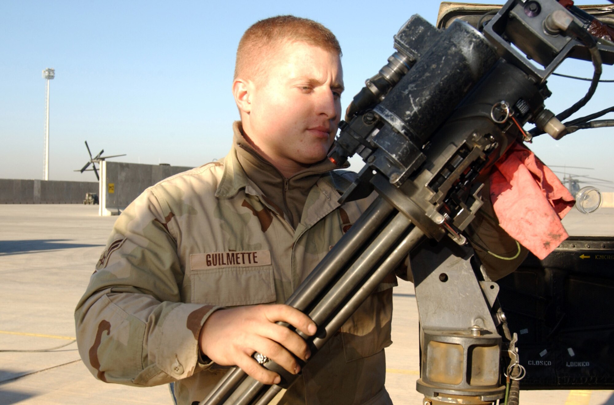 BALAD AIR BASE, Iraq (AFPN) -- Armament specialist Airman 1st Class Casey Guilmette cleans the mini gun on an HH-60G Pave Hawk helicopter. The Airman is one of more than 30 64th Expeditionary Helicopter Maintenance Squadron troops that keep helicopters here ready for their around-the-clock combat search and rescue missions, whether they are routine or a matter of life and death. (U.S. Air Force photo by Tech. Sgt. Pamela Anderson) 