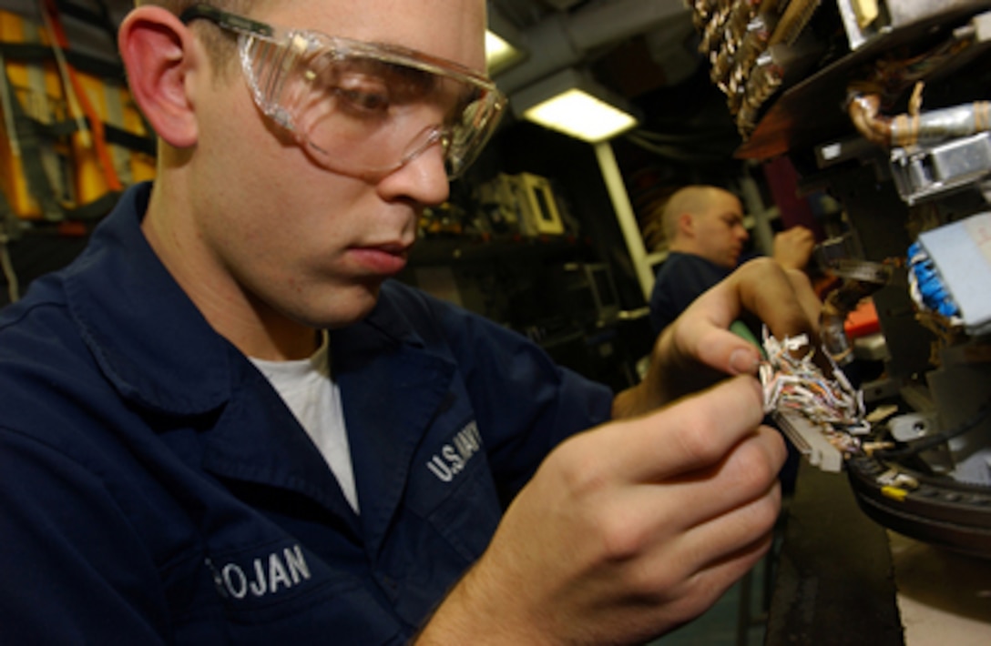 U.S. Navy Airman Marty Trojan replaces a connector on an infrared receiver aboard the aircraft carrier USS Theodore Roosevelt (CVN 71) on Dec. 6, 2005. Trojan is a Navy aviation electronics technician on the Roosevelt, which is conducting maritime security operations in the Persian Gulf. 