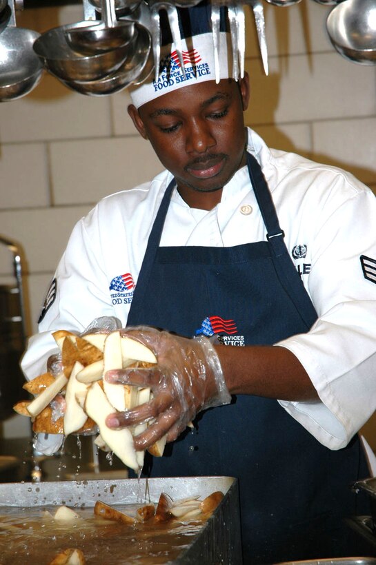 Senior Airman Balfour Walker, 1st Services Squadron food service specialist, rinses and prepares more than 150 servings of potatoes at the Eagle Room dining facility. This colossal food service operation served more than 480,000 meals in the last year with an average 4.8 out of 5 satisfactory rating. (U.S. Air Force photo by Tech. Sgt. Russel Wicke)
