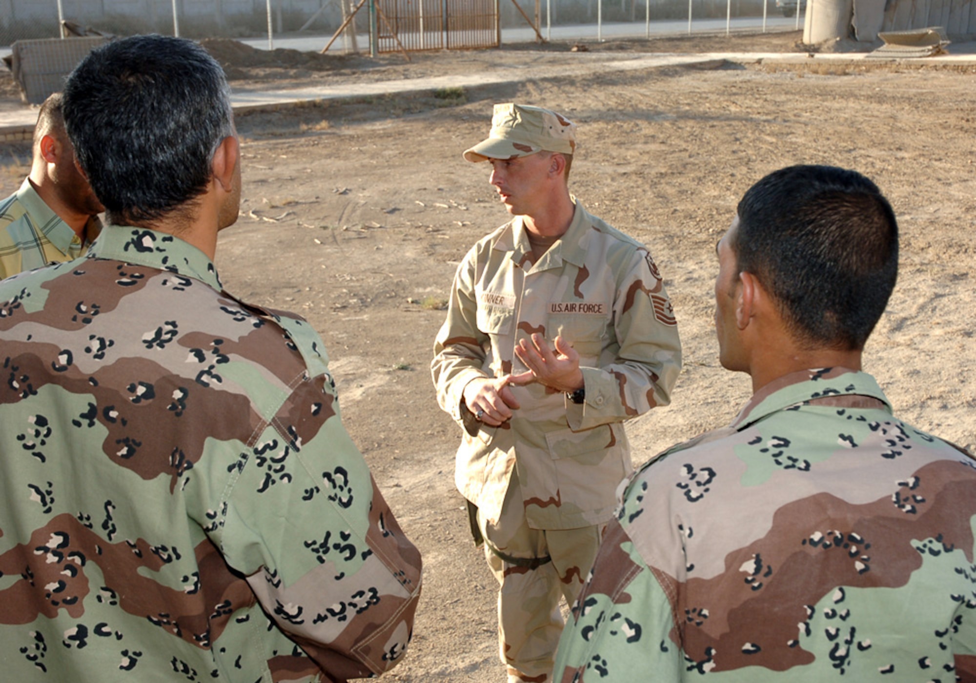 BAGHDAD, Iraq (AFPN) -- Tech. Sgt. Jared Skinner instructs Iraqi protection force trainees on search techniques. The sergeant is one of three security forces troops training Iraqi protection forces at New Al Muthana Air Base here. Sergeant Skinner is deployed from Air Force Materiel Command headquarters at Wright-Patterson Air Force Base, Ohio. (U.S. Air Force photo by Master Sgt. Randy L. Mitchell)