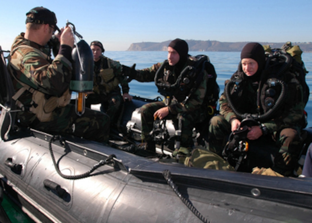 Divers from the U.S. Navy's Special Clearance Team 1 prepare for a dive off the coast of Point Loma in San Diego, Calif., on Dec. 7, 2005. The training dive allowed French divers to observe the team's divers and their procedures. The U.S. Navy divers will travel to Toulon, France, in February to observe the French divers in an amphibious exercise. 