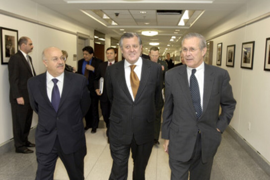 Secretary of Defense Donald H. Rumsfeld (right) escorts Peruvian Minister of Foreign Affairs Oscar Maurtua (center) and Peruvian Ambassador to the United States Eduardo Ferrero (left) to a Pentagon conference room on Dec. 12, 2005. Rumsfeld, Maurtua and Ferrero are meeting to discuss bilateral security issues. 