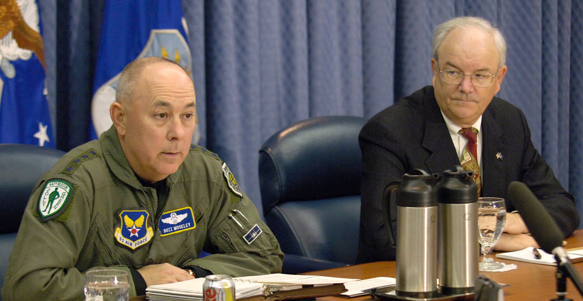 WASHINGTON (AFPN) -- Chief of Staff of the Air Force Gen. T. Michael Moseley (left) -- with Secretary of the Air Force Michael W. Wynne at his side -- answers a reporter's question during a media round table discussion at the Pentagon Dec. 13. (U.S. Air Force photo by Master Sgt. Jim Varhegyi)
