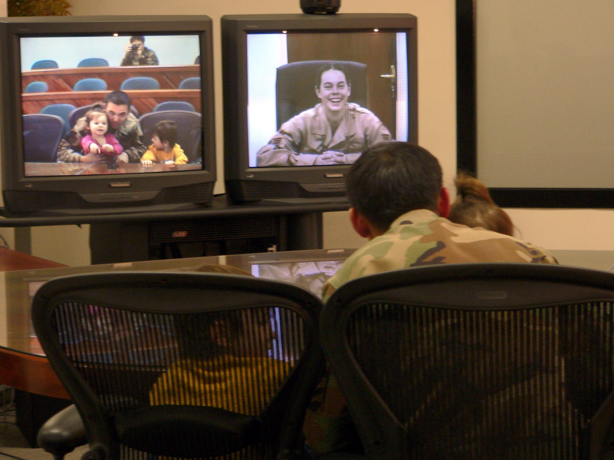 MISAWA AIR BASE, Japan (AFPN) -- Senior Airman April Ellis (on screen) talks to her husband, Staff Sgt. Christopher Ellis; her son, Christian; and her daughter, Faith, during a morale video teleconference call Dec. 13. Airman Ellis is deployed to Balad Air Base, Iraq. The Ellis's are with the 35th Maintenance Squadron here. (U.S. Air Force photo by Staff Sgt. A.C. Eggman)