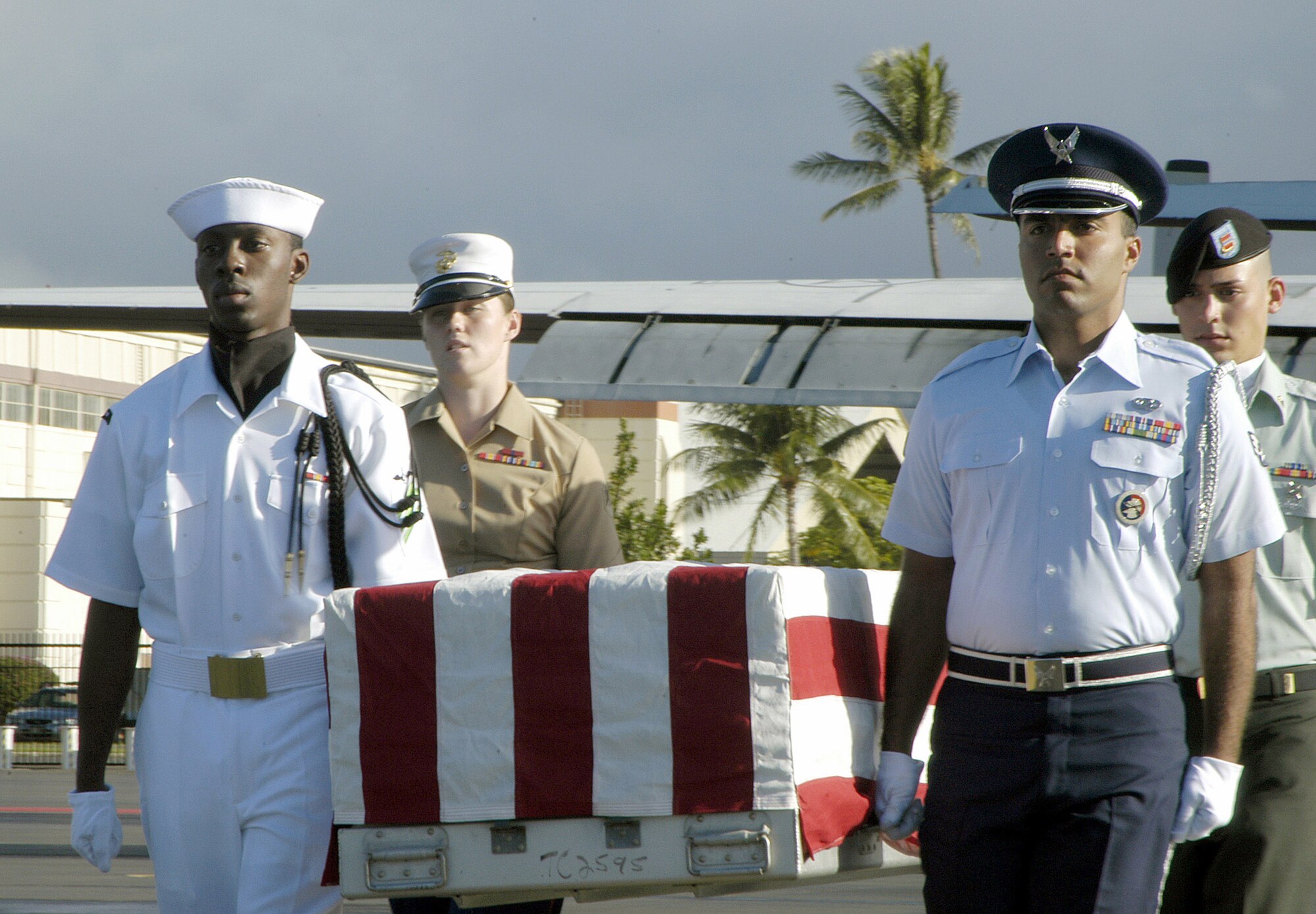 HICKAM AIR FORCE BASE, Hawaii (AFPN) - A joint honor guard moves the remains of a Vietnam War veteran during a repatriation ceremony here. The Joint POW/MIA Accounting Command held the ceremony Dec. 9. The remains were recovered last month by a JPAC team. (U.S. Air Force photo by Staff Sgt. Derrick C. Goode)